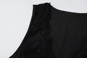 Macro shot of black dress showing intricate scalloped lace trim and knit fabric texture