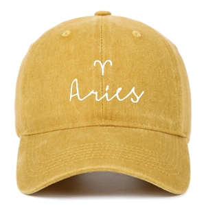 Close-up of Aries zodiac embroidery on vintage washed cotton mustard yellow baseball cap