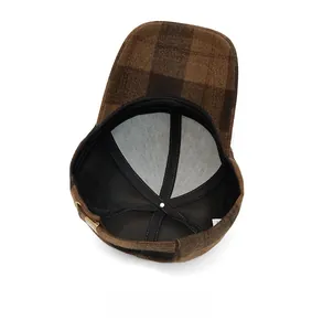 Internal structure of brown plaid baseball cap showing mesh lining and black sweatband