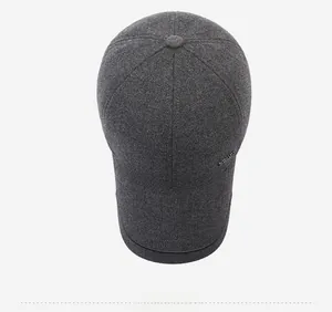 Top view of dark grey thermal baseball cap with wool texture and metal accent detail