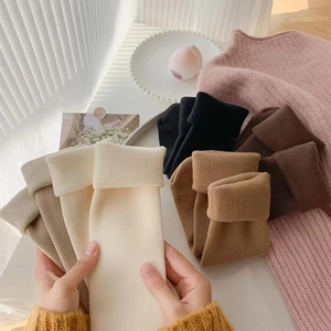 Detailed close-up of thick ribbed knit thermal snow socks in various warm earth tones