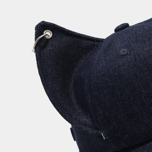 Close-up of distressed denim baseball cap with 3D cat ears and a silver metal ring