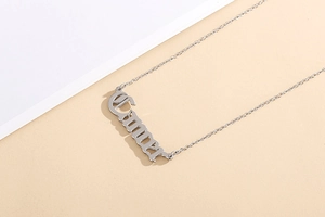 Detailed macro view of the silver stainless steel necklace with custom Emma gothic pendant