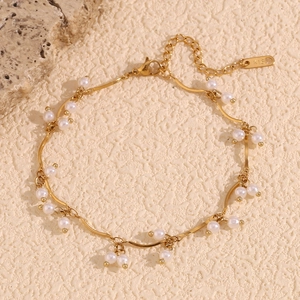 Detailed close-up of 18K gold plated chain with white pearl charms and K18 hallmark