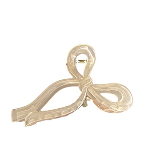 Elegant cream-colored oversized ribbon bow hair claw clip for high ponytail styling