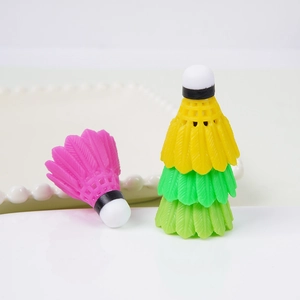 Llaveros de mini volante de bádminton de PVC en varios colores sobre un plato cerámico