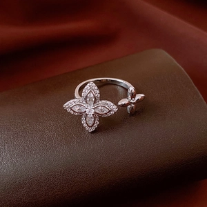 Macro detail of silver floral ring with marquise zircon petals on leather stand