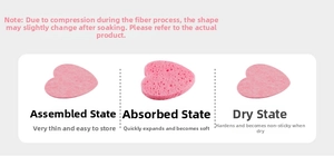 Pink heart compressed wood pulp sponge showing expansion before and after water absorption