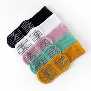Detailed view of non-slip yoga socks set in black, white, pink, green, and yellow