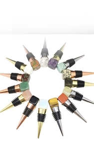 Variety of natural crystal wine stoppers with colorful stone tops and metal seals
