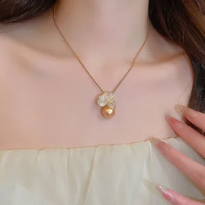 Elegant gold flower pearl necklace with sparkling zircon pendant on model neck