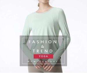 Detail of mint green long sleeve yoga top featuring thumbholes and moisture-wicking fabric
