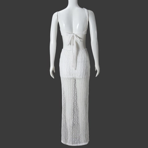 Detail view of white crochet two-piece set featuring backless lace-up top and long skirt