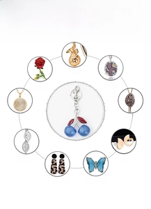 Detailed view of polished cherry keychain crafts with vibrant blue coating and alloy texture