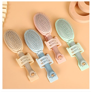 Detail of four colorful portable hairbrushes with animal ear handles on warm background