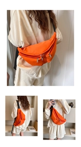 Macro detail of vibrant orange nylon crossbody bag with multiple silver zipper pockets