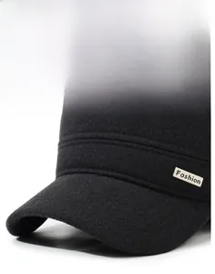 Detail of reinforced brim and fashion logo on warm wool flat cap for elderly men