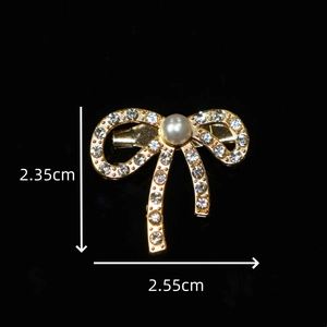 Sparkling gold bow brooch with rhinestones and white pearl inlay, 2.55cm width