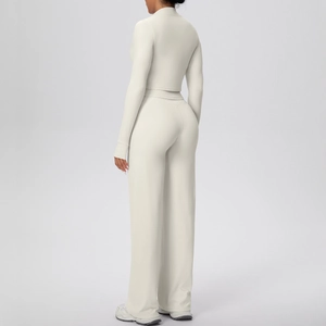Detailed rear view of cream yoga set showing long sleeve crop top and wide leg pants