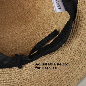Detail of raffia sun hat featuring adjustable velcro strap and black sweatband inside