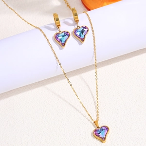 Detail shot of heart jewelry set featuring blue-purple crystals and gold-plated chain