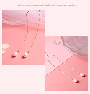 Elegant gold and silver long tassel earrings with teardrop pearls on a soft pink background
