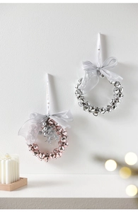 Detail of pink and silver Christmas bell wreaths with Merry Christmas ribbon