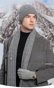 Winter 3-piece set with knitted hat scarf and gloves worn against a snowy mountain background
