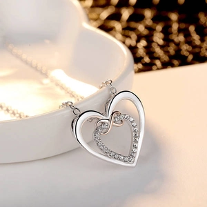 Elegant silver and rose gold double heart necklace with infinity symbol and crystals
