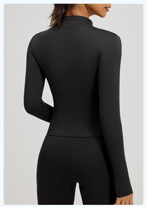 Rear view of slim fit black long sleeve yoga top and high waist sports leggings