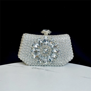 Macro detail of silver crystal evening clutch with sparkling floral rhinestone pattern