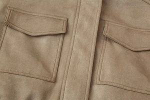 Detail of suede jacket with cargo flap pockets and professional contrast stitching