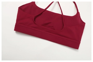 Detail of cross back straps on burgundy yoga bra with high-elastic fabric and stitching
