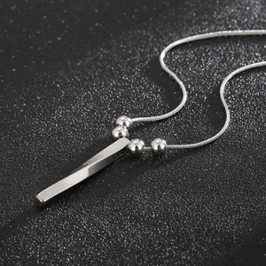 Modern twisted silver bar pendant necklace with five beads on a sleek snake chain
