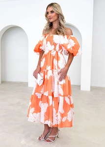 Detail of off-shoulder floral dress featuring puff sleeves and high waist tie design