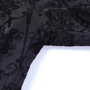 Close-up of black mesh fabric with floral flocked patterns and precise sewing details