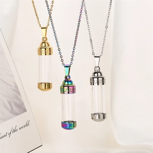Detailed view of three fillable perfume bottle pendants in gold, silver, and rainbow steel
