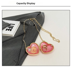 Macro detail of heart-shaped mini bag with gold chain on a suit jacket background