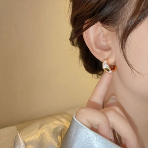 Elegant French style earring featuring zircon and pearl details shown on an ear