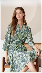 Detail of tropical palm leaf print bathrobe with waist belt and elegant wrap design
