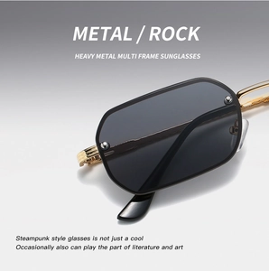 Detail of gold metal punk sunglasses with black lenses and mechanical rivet elements