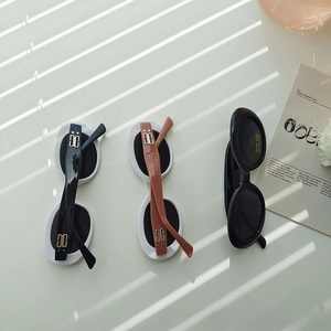 Close-up of retro oval kids sunglasses with UV400 lenses and CE certified frames