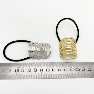 Detailed view of hollow metal ponytail holder measuring 3cm on a white background