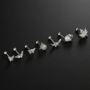 Detailed row of surgical steel cartilage studs featuring micro-pave zircon butterfly and skull