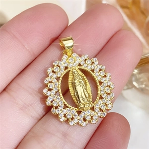 Detailed view of a gold circular Virgin Mary pendant with white sparkling zircon stones