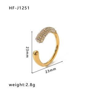 Detailed view of gold-tone irregular ring with sparkling zircon inlays, 23mm size