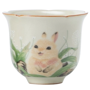 Ru-kiln ceramic teacup with rabbit design and floral petal rim on a clean white background