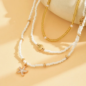 Three-layer beaded necklace set with golden starfish pendant and shell charms