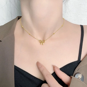 Elegant gold bow pendant necklace on a delicate beaded chain for women fashion