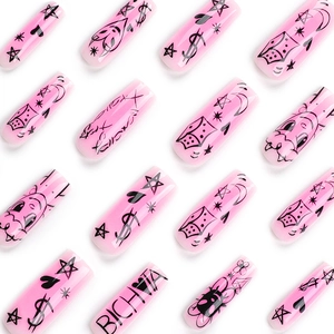 Pink press-on nails with black star and moon graffiti pattern in long trapezoid shape